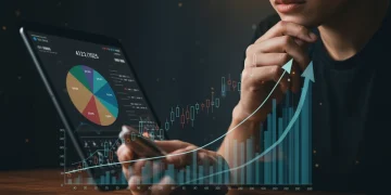 Thoughtful individual reviewing 401(k) growth on a tablet for 2025 retirement planning