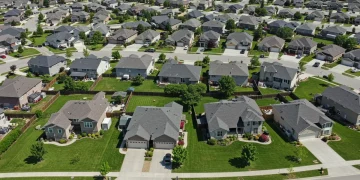 Modern suburban homes under a blue sky, symbolizing housing market stability and growth.